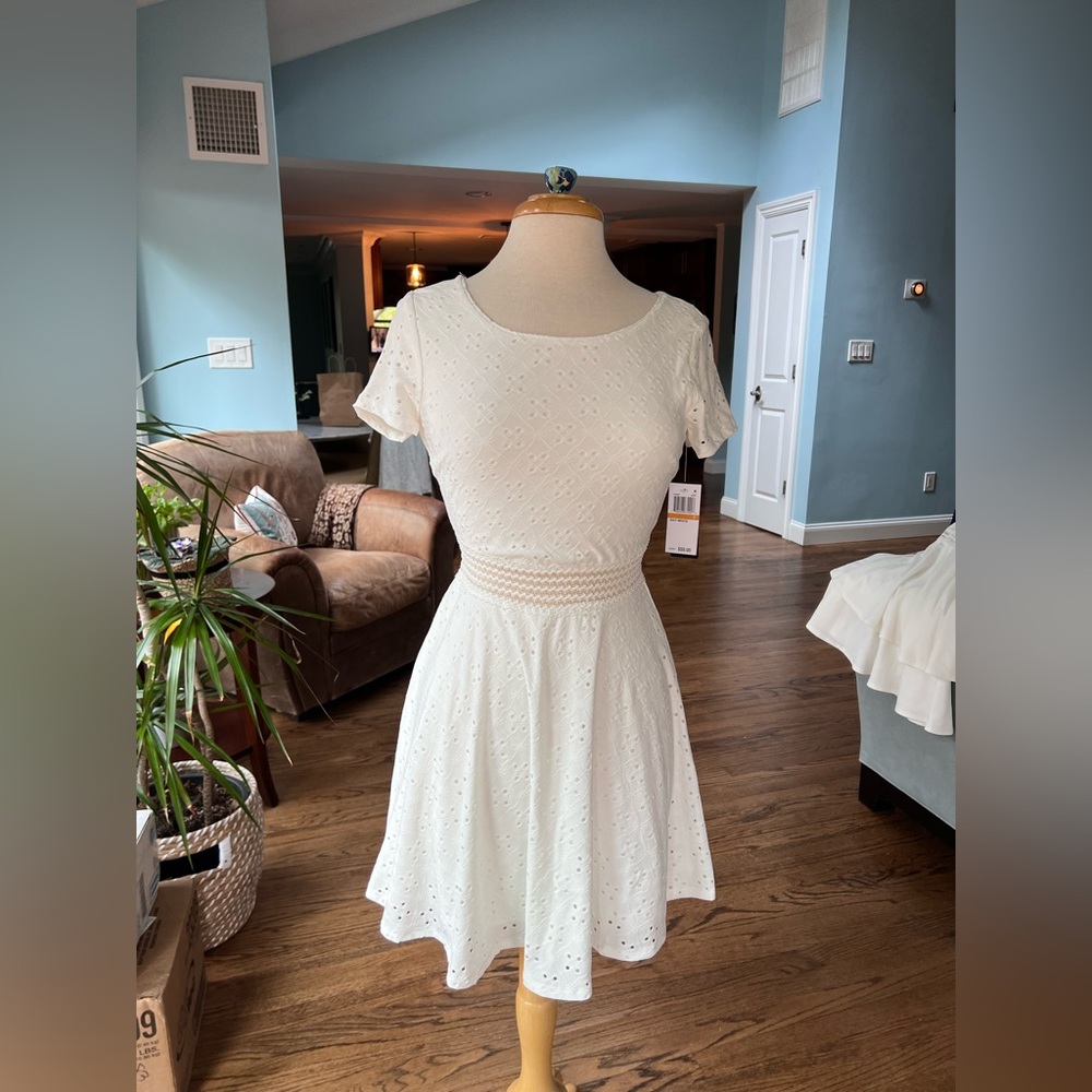 White, fit and flare, dress that falls a few inches above the knee. Size 3.